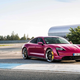 A brightly colored Porsche Taycan on a race track